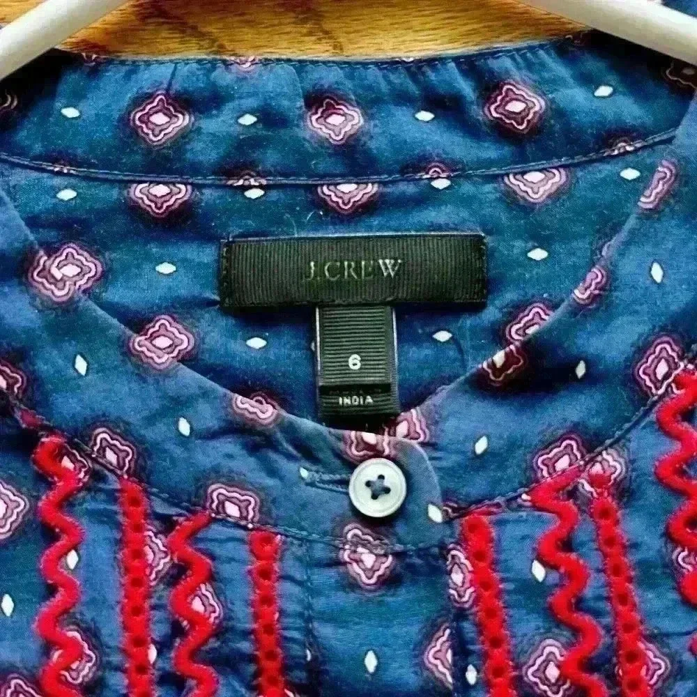 JCREW Women’s navy and red blouse with ruffle detail and button closure.…